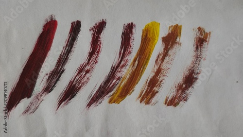 Fotografie Set of warm tone paint brush strokes on white paper surface texture