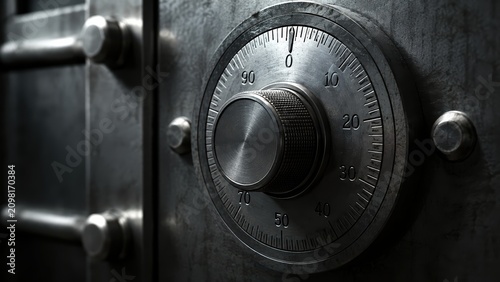Close-up of a metallic safe combination lock dial on a steel vault door