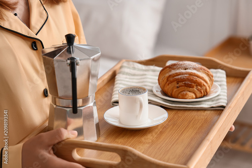 Woman in pajamas holding a ...