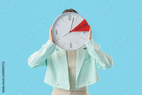 Person holding a clock with...