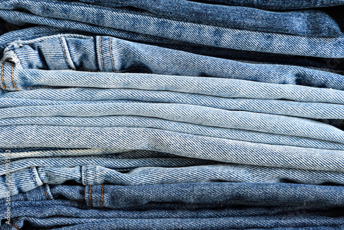 Stack of folded blue denim ...