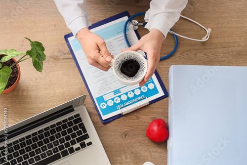 Doctor holding a cup of cof...