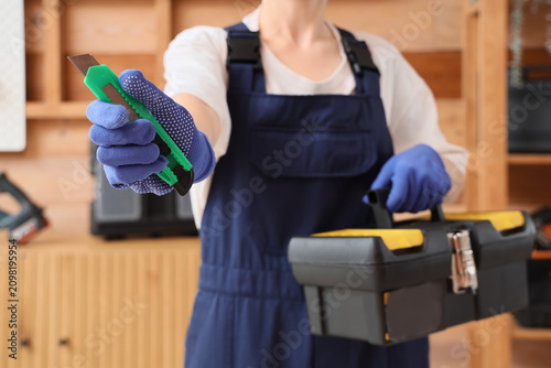 Worker in blue overalls and...