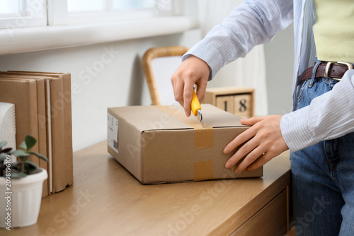 Person opening a cardboard ...