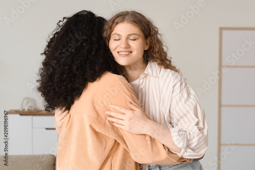 Two diverse young women emb...