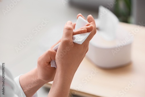 Woman wiping her hands with...