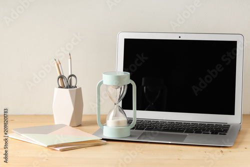 Hourglass and laptop on tab...