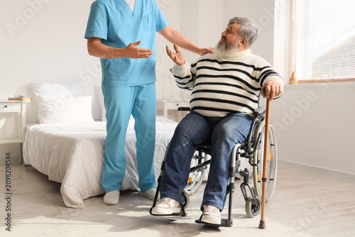 Senior man in wheelchair ta...