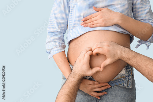 Young pregnant woman and he...