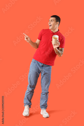 Young man holding french fr...