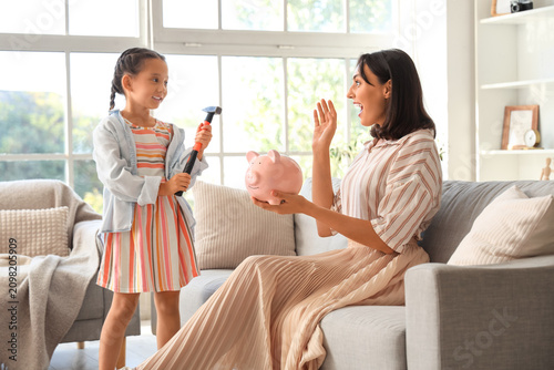 Little girl with hammer and...