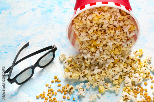 Bucket with tasty popcorn a...