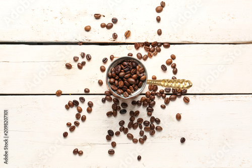 Pot with coffee beans on li...
