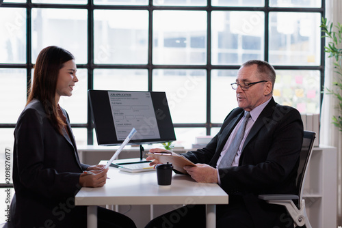 Фотография Professional recruiter interviewing young asian female candidate for a new job o