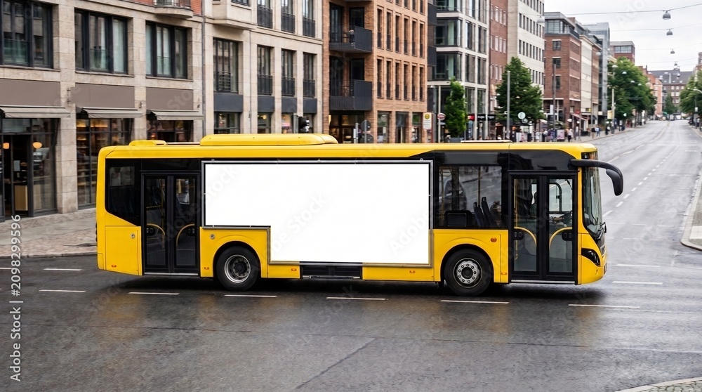 Obraz premium Yellow city bus with blank advertising panel. Public transport vehicle mockup on a street in town.