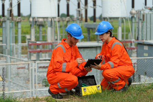 Electrical engineers are checking the operation and power distribution systems within the substation receiving power from the wind farm.	