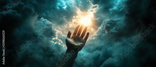 Reaching Hand Towards Bright Sunlight Through Dramatic Stormy Clouds