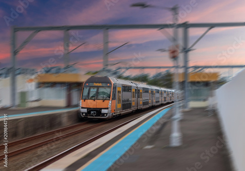 Passenger Train going through Lewisham Train Station at Sunset a suburban Sydney train Station in Sydney NSW Australia