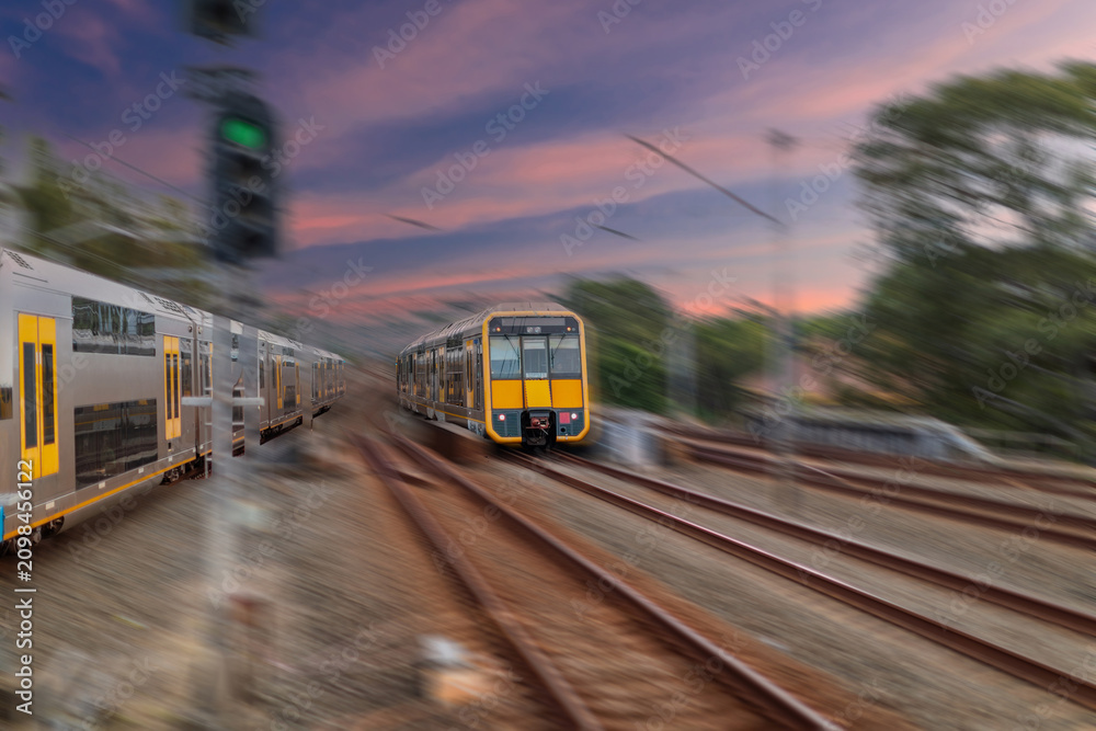 Obraz premium Passenger Train going through Lewisham Train Station at Sunset a suburban Sydney train Station in Sydney NSW Australia