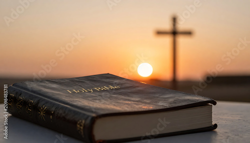 Scripture book with blurred cross silhouette in the background