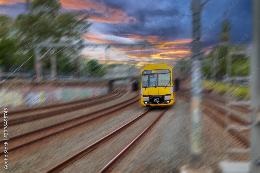Obraz premium Passenger Train going through Lewisham Train Station at Sunset a suburban Sydney train Station in Sydney NSW Australia