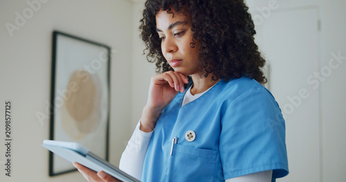 Obraz na płótnie Nurse, woman and thinking with tablet for reading medical report, telehealth and research in clinic