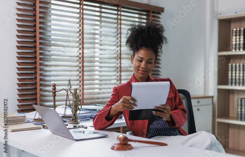 African american female lawyer reviewing legal documents in office