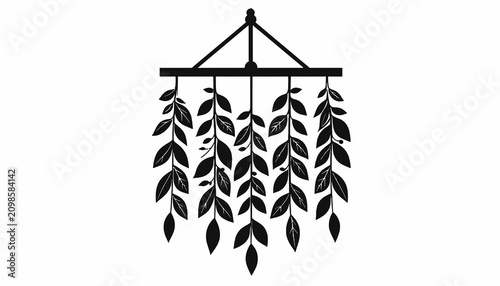 фотографія Black silhouette of hanging leaf decoration.