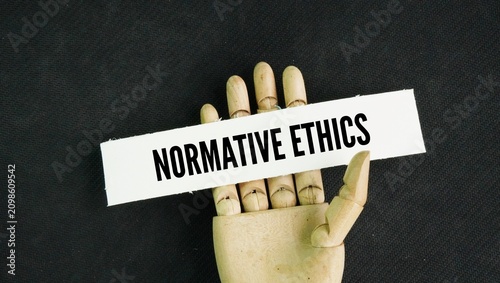 Canvastavla Hand and paper with the word Normative Ethics