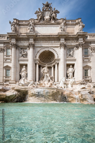 Perfectly symmetrical vertical view of the majestic Trevi Fountain with clear turquoise water in Rome, Italy