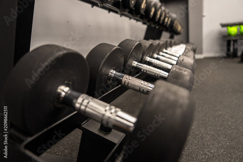 Dumbbells and kettlebells arranged in a modern gym, highlighting strength training equipment used for fitness, bodybuilding, endurance, and functional workout routines.