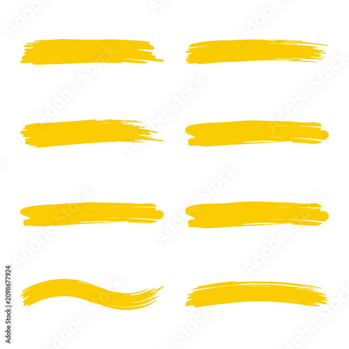 Foto Vibrant yellow hand-painted brush strokes on a white background