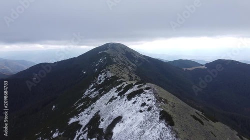 Aerial panorama of rocky mountain ridge with early snowfall