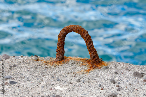 Old, rusting bollard at the harbor