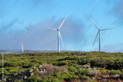 The wheels of a wind turbine are turning on the plateau of Madeira.