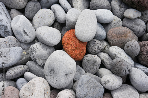 stones on the beach and one is colored by nature