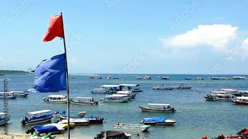 Traditional Boats Anchored in a Tropical Harbor Under Clear Blue Sky