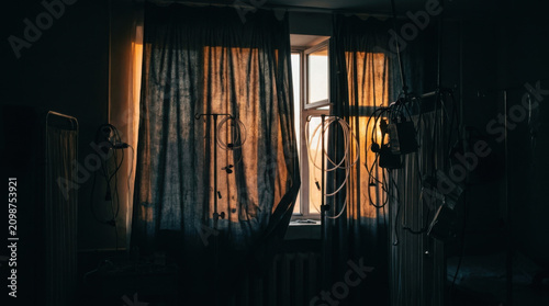Dramatic Window Light Through Curtains In A Dimly Lit Room