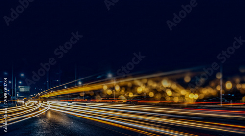 Gold white light trail streaks bottom dark city dissolving navy upper copy space, growth