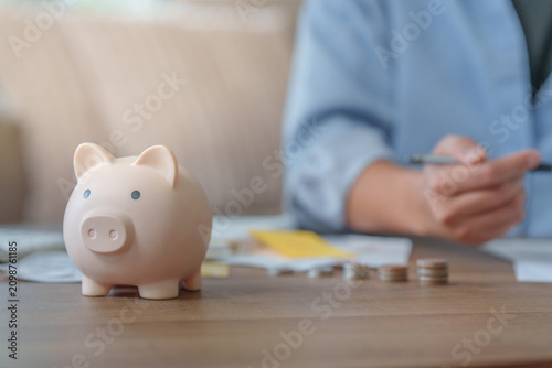 Savings and tax refund concept with piggy bank on table