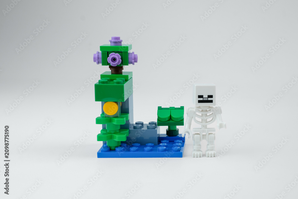 Obraz premium A Minecraft-style fantasy block structure is displayed beside a small skeleton toy figure on a white background on Apr 13, 2026 in Jakarta, Indonesia