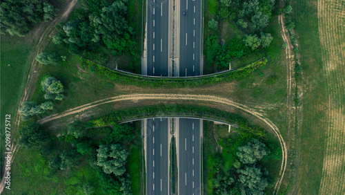 Canvastavla Aerial view of a wildlife overpass crossing a motorway near a lake