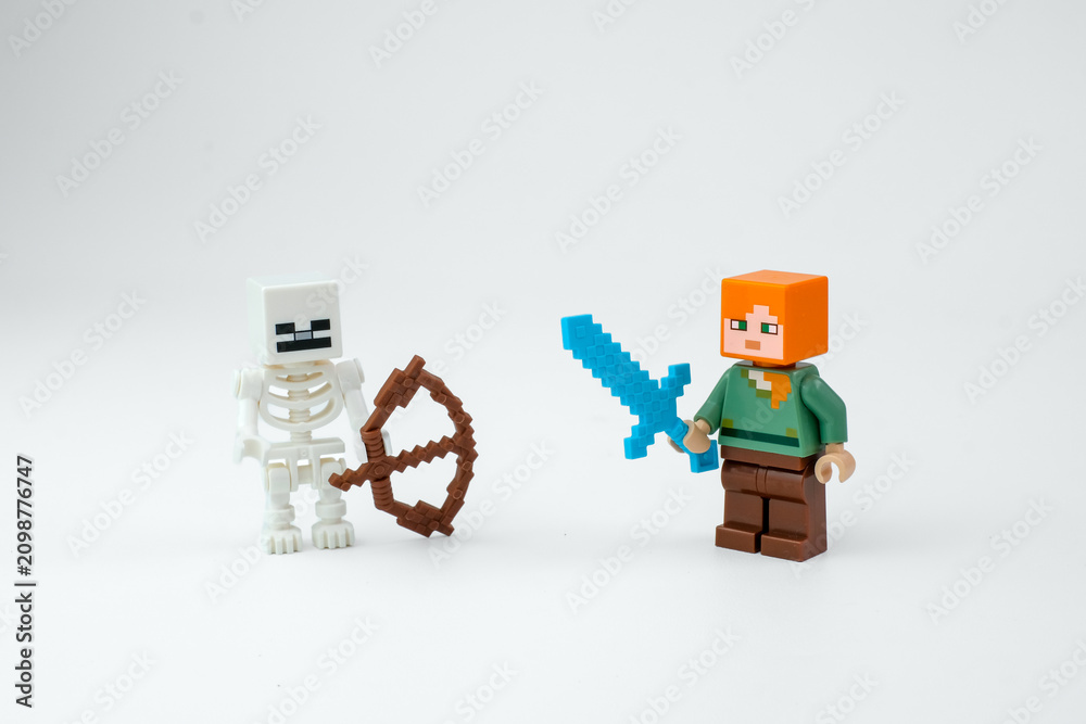 Obraz premium A Minecraft-style skeleton toy, brown bow, and block character holding a blue sword are displayed on a white background on Apr 13, 2026 in Jakarta, Indonesia