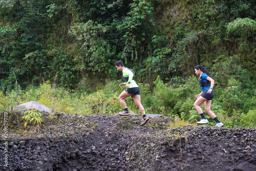 Trail Running Athletes Climbing Rocky Volcanic Path