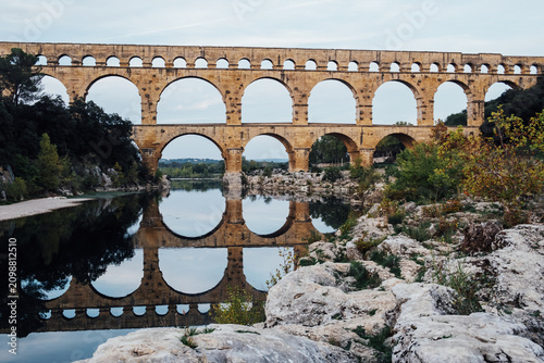 The ancient Roman aqueduct bridge Pont du Gard, tourist attraction and travel destination in South of France.