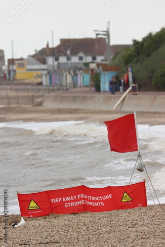Red flag, signifying 'do not swim' , on beach at Clacton on Sea, Essex, UK