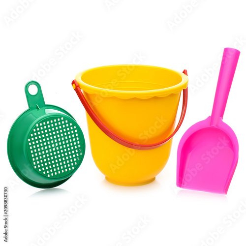 Childrens bright plastic sandbox toy set: yellow bucket, green sieve, and pink shovel