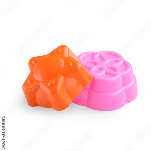 A set of children's molds for creating sand shapes on a white background.