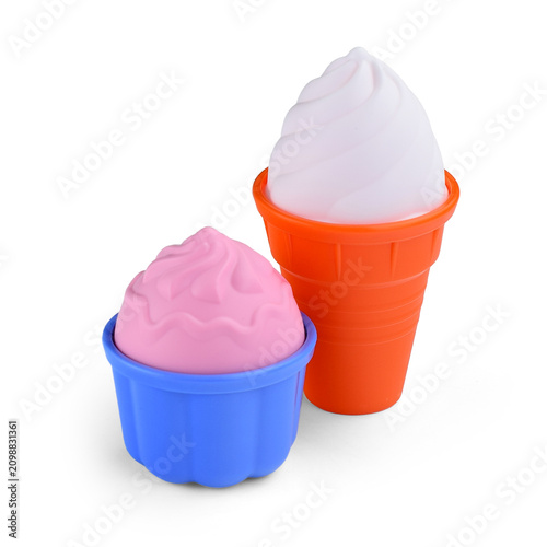 Ice cream and cupcake plastic sand molds on white background