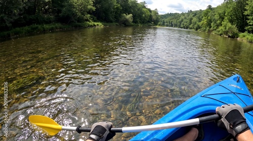 First Person View of Kayaking on a Clear River Through a Lush Forest
